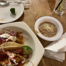 Breaded shrimp tacos and side of beans Breaded shrimp tacos and side of beans