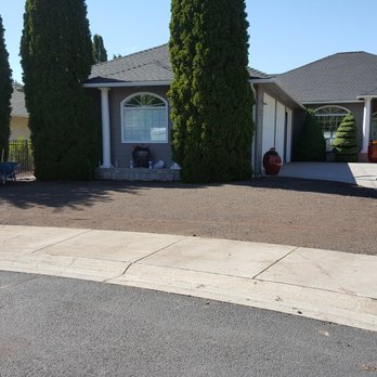 Oliva Lawn Care - a man laying on the ground in front of a house - Tree Services Near Me - Central Point, Oregon Oliva Lawn Care - a man laying on the ground in front of a house - Tree Services Near Me - Central Point, Oregon
