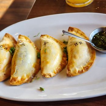 El Gaucho Grill - Variety of empanadas (stamps tell you what's inside) and side of chimichurri - Argentine Near Me - Brookfield, Wisconsin El Gaucho Grill - Variety of empanadas (stamps tell you what's inside) and side of chimichurri - Argentine Near Me - Brookfield, Wisconsin