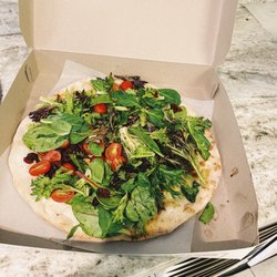 Salty Tomato Pizza - Salad Pizza: mixed greens, cucumbers, tomatoes, sundried cranberries tossed in a vinaigrette