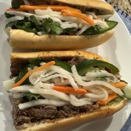 Grilled pork on top and lemongrass beef on bottom. Grilled pork on top and lemongrass beef on bottom.