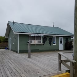 Sand Bar & Grill - Exterior view of the location. On the right is a door leading into a small seating area, and on the left is a window for walk-up service