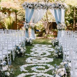 Dream Flowers - A ceremony at private residence: a chuppa in white, blue and blush colors and rose petals down the aisle