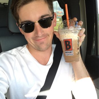 BIGGBY COFFEE - a man in a car holding a drink - Coffee & Tea Near Me - Okemos, Michigan BIGGBY COFFEE - a man in a car holding a drink - Coffee & Tea Near Me - Okemos, Michigan