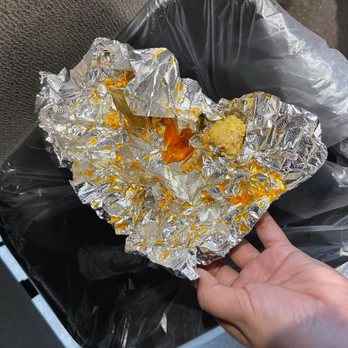 Tortilleria La Sabrosa - a hand holding a piece of foil - Mexican Near Me - Plano, Texas
