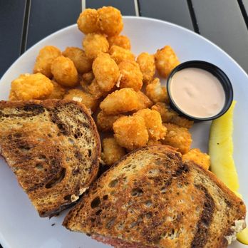 Acorn Grill + Terrace - Reuben with corned beef, sauerkraut, Swiss cheese, Thousand Island dressing (on the side), toasted multigrain ($15), a side of Tater Tots. - Breakfast & Brunch Near Me - Northbrook, Illinois