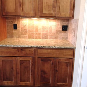 Carpet Direct - a kitchen with wooden cabinets and granite counter tops - Carpeting Near Me - Pueblo West, Colorado
