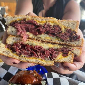 Nighthawks - a person holding a sandwich with meat and cheese - Diners Near Me - Minneapolis, Minnesota Nighthawks - a person holding a sandwich with meat and cheese - Diners Near Me - Minneapolis, Minnesota