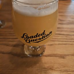 a glass of beer on a table a glass of beer on a table