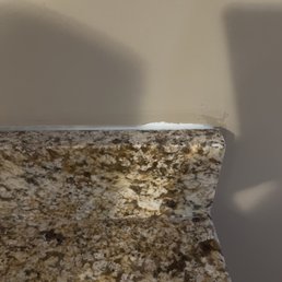 This is how they secured granite behind the sink area. This is how they secured granite behind the sink area.