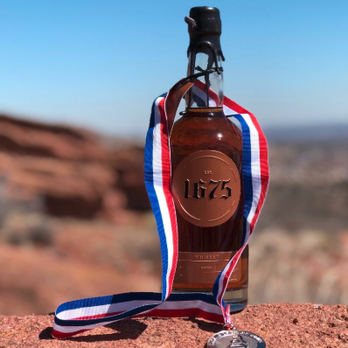 1675 Spirits - a bottle of whiskey with a ribbon around it - Distilleries Near Me - Bensalem, Pennsylvania