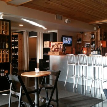 750 Ml Wines - a bar with people sitting at it - Wine Bars Near Me - Akron, Ohio