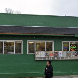 people standing outside of a restaurant people standing outside of a restaurant