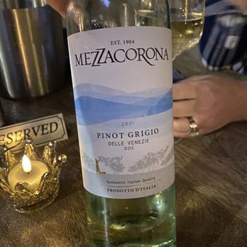 Kork Sips & Snacks - a person holding a bottle of wine - Wine Bars Near Me - Fair Oaks, California Kork Sips & Snacks - a person holding a bottle of wine - Wine Bars Near Me - Fair Oaks, California