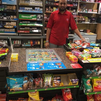 Circle K - a man standing behind a counter in a grocery store - Convenience Stores Near Me - Costa Mesa, California