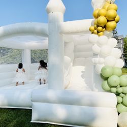 Bounce Around The Hudson - White luxe bounce house rental with balloons