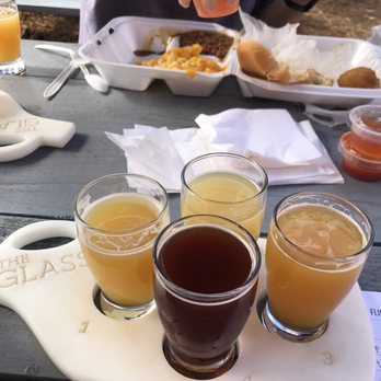 The Glass Jug Beer Lab - Flight of hazy IPAs and the Fourth Dimension sour brewed in house! Also pictured: Backyard BBQ takeout. - Beer Bar Near Me - Durham, North Carolina The Glass Jug Beer Lab - Flight of hazy IPAs and the Fourth Dimension sour brewed in house! Also pictured: Backyard BBQ takeout. - Beer Bar Near Me - Durham, North Carolina