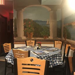 quaint round table seating in back corner of dining room