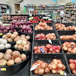 Rogers Food Mart - Onions, garlic, tomatoes and avocados; pickles, olives and salad dressing on the right.