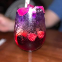 a close up of a wine glass with a drink in it a close up of a wine glass with a drink in it