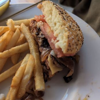 Tack Room Tavern - This is the veggie burger with cooked onions, tomato, special bun and french fries. Delicious, delicious, delicious - American Near Me - Indio, California