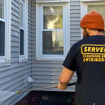 Servello Cleaning - uniformed employee pressure washing vinyl siding - Pressure Washers Near Me - Montgomery, Massachusetts