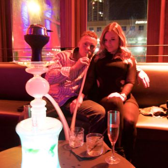 Hookah Social - a man and a woman sitting on a couch - Hookah Bars Near Me - Austin, Texas