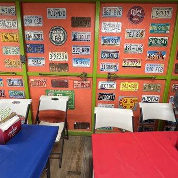 La Carreta del Rorro - tables and chairs in front of a wall of license plates - Food Trucks Near Me - Tucson, Arizona