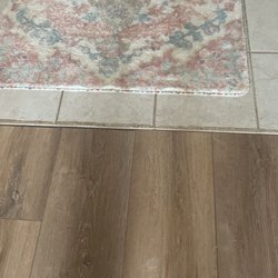 Dave’s Construction Design - Unfinished transition strips not done leaving gap between the floorings