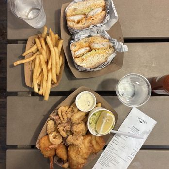 The Hook - Hot Sandwich: ciabatta bread, coleslaw, dressing, fish, side of fries (top), Seafood Combo: fish, shrimp, calamari, fries (bottom) - Seafood Near Me - San Francisco, California