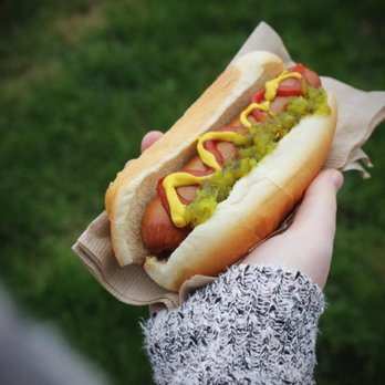 QuikTrip - a person holding a hot dog with mustard and ketchup - Convenience Stores Near Me - Fort Worth, Texas