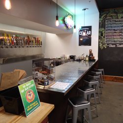 The Cellar by Bottle No 121 - Have a seat at the bar and get a flight of beers from our 22 handle growler station