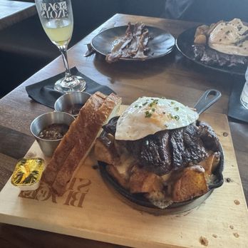 Blackstone Kitchen - The Skillet, Potatoes with pepper jack cheese topped with a skirt steak and an egg (your way) with sourdough toast - New American Near Me - Corona, California