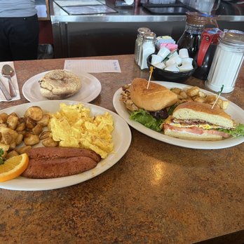 The Coffee Cup Cafe - Left: Louisiana hot sausage with potatoes and scrambled eggs, Right: breakfast sandwich with bacon and eggs - American Near Me - Long Beach, California The Coffee Cup Cafe - Left: Louisiana hot sausage with potatoes and scrambled eggs, Right: breakfast sandwich with bacon and eggs - American Near Me - Long Beach, California