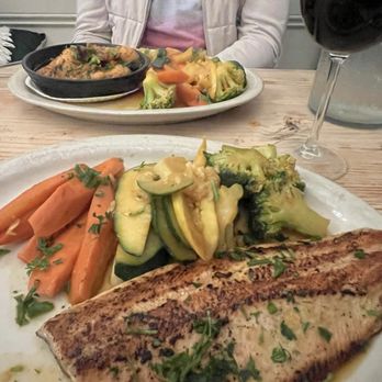 Lola's - Trout and veggies. Garlic Chicken in the background. - Spanish Near Me - New Orleans, Louisiana Lola's - Trout and veggies. Garlic Chicken in the background. - Spanish Near Me - New Orleans, Louisiana