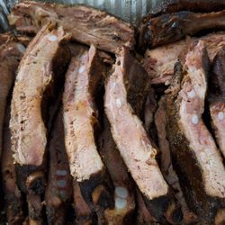 2 slabs of BBQ pork ribs, sauce on side, very nice of them to cut it for us