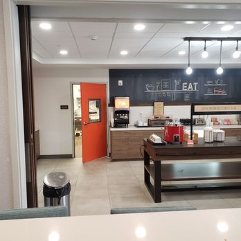 Hampton Inn & Suites Keene - Kitchen Door Ajar Leading to Breakfast Area - Hotels Near Me - Keene, New Hampshire