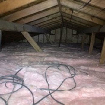 Attic Cleaning Services - BEFORE radiant barrier aluminum. Look at this THICK bed of insulation. I asked him to leave cable on top for other workers. - Insulation Installation Near Me