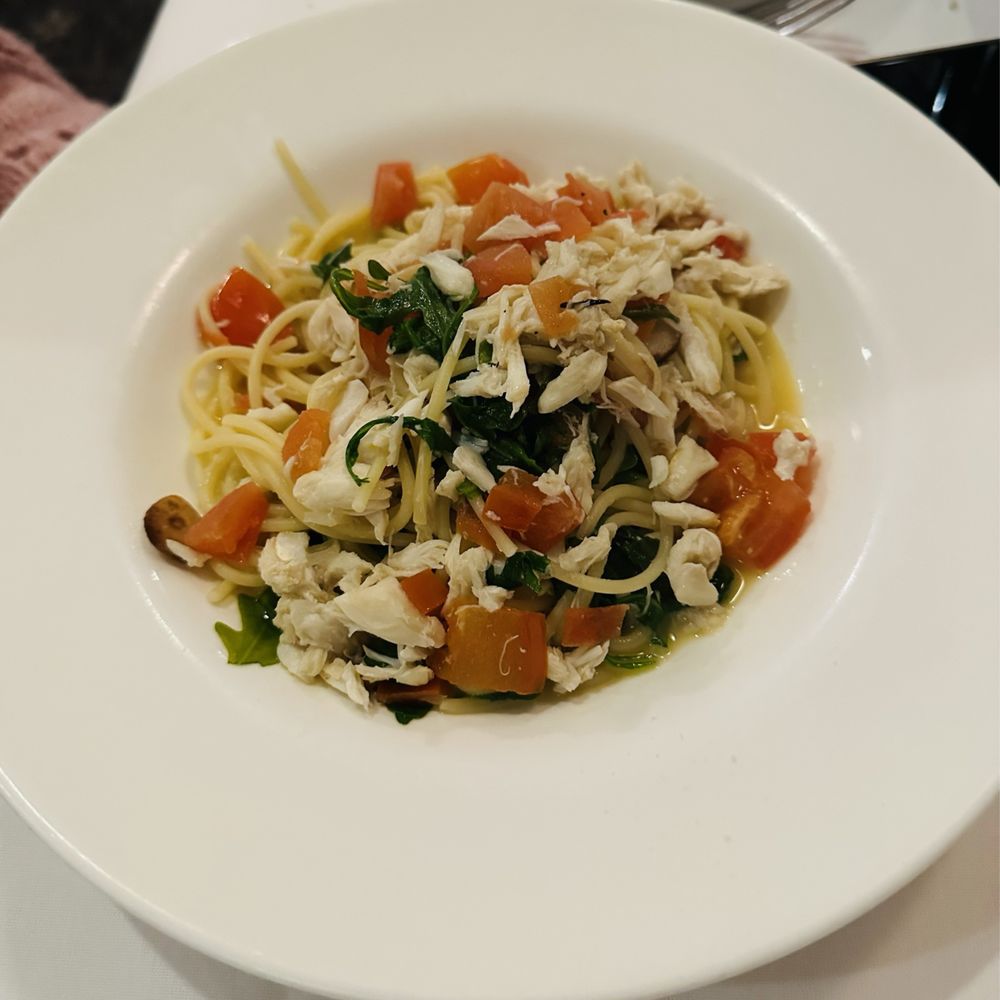 Osteria Trevi - Spaghetti Integrali Al Granchio Asked for regular spaghetti , Jumbo Lump Crab Meat, Baby Arugula, Fresh Diced Tomatoes, Garlic Butter Sauce - Italian Near Me - Madison, New Jersey
