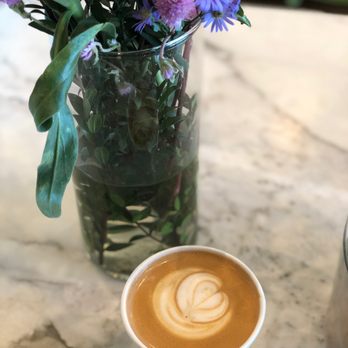 Holsem Coffee - Almond Latte with flowers in the background - Coffee & Tea Near Me - San Diego, California Holsem Coffee - Almond Latte with flowers in the background - Coffee & Tea Near Me - San Diego, California
