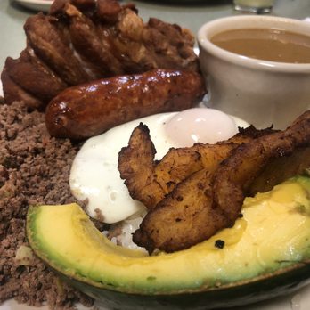 La Pollera Colorada - Bandeja montañera con carne molida: mountain platter w/ ground beef, fried egg, sweet plantains, pork rinds, beans, Colombian sausage & avo - Colombian Near Me - Clearwater, Florida La Pollera Colorada - Bandeja montañera con carne molida: mountain platter w/ ground beef, fried egg, sweet plantains, pork rinds, beans, Colombian sausage & avo - Colombian Near Me - Clearwater, Florida