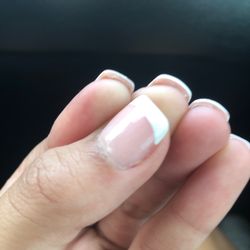 N V Us Nail Salon - Left acrylic and gel nail polish under finger nail.