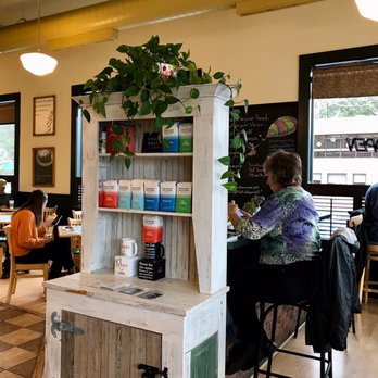 Quotations Coffee Spot - a woman sitting at a table - Coffee & Tea Near Me - Brevard, North Carolina
