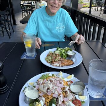 Fresh Chef - My wife of 55 years of marital bliss enjoying her girllled salmon with my chef's salad in the foreground. - American Near Me - Huntersville, North Carolina Fresh Chef - My wife of 55 years of marital bliss enjoying her girllled salmon with my chef's salad in the foreground. - American Near Me - Huntersville, North Carolina