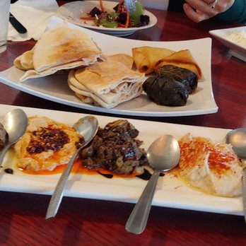 Pom & Olive - Sampler Appetizer Platter: Black bean hummus, spicy hummus, stuffed olives, hummus, babaganoush w/ Pita bread, 2 pcs dolmas, 2 pcs Samosas. - Mediterranean Near Me - Costa Mesa, California Pom & Olive - Sampler Appetizer Platter: Black bean hummus, spicy hummus, stuffed olives, hummus, babaganoush w/ Pita bread, 2 pcs dolmas, 2 pcs Samosas. - Mediterranean Near Me - Costa Mesa, California