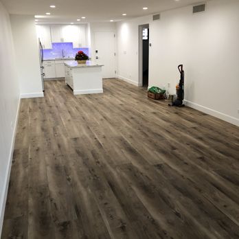 Innovative Builders 808 - Open concept kitchen and living room with new SPC vinyl flooring. - General Contractors Near Me Innovative Builders 808 - Open concept kitchen and living room with new SPC vinyl flooring. - General Contractors Near Me