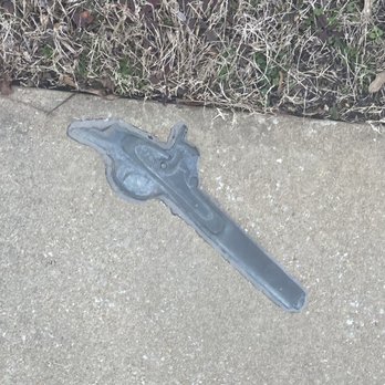 Corinth Interpretive Center - Bronze partial gun in the sidewalk representing some of the artifacts left behind at the site - Landmarks & Historical Buildings Near Me - Corinth, Mississippi Corinth Interpretive Center - Bronze partial gun in the sidewalk representing some of the artifacts left behind at the site - Landmarks & Historical Buildings Near Me - Corinth, Mississippi