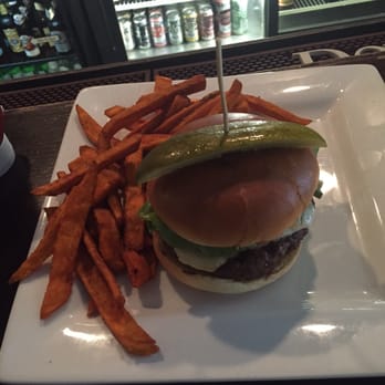 T.J. Stone’s - TJ Stones burger with sweet potato fries and just some of their beer selection in the background. - Bars Near Me - Alexandria, Virginia T.J. Stone’s - TJ Stones burger with sweet potato fries and just some of their beer selection in the background. - Bars Near Me - Alexandria, Virginia