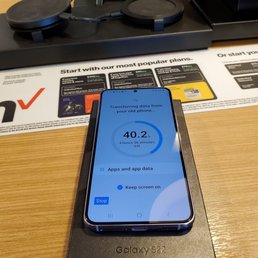 New phone (Galaxy S22) receiving data from old phone. Background is the desk at which we sat with the employee. New phone (Galaxy S22) receiving data from old phone. Background is the desk at which we sat with the employee.
