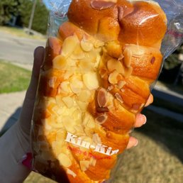 a hand holding a bag of buns a hand holding a bag of buns